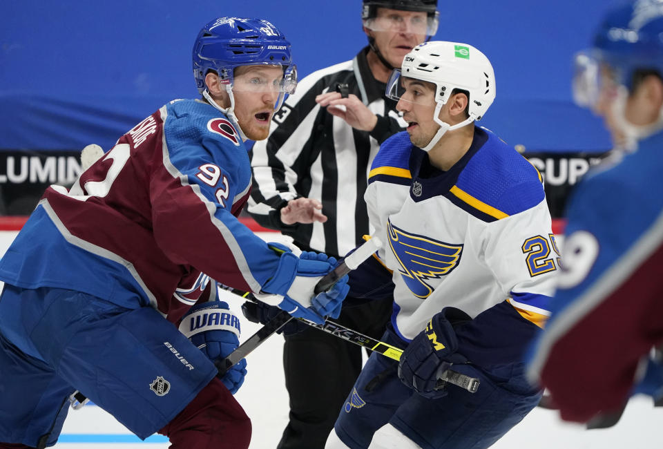 Colorado Avalanche left wing Gabriel Landeskog, left, pursues the puck with St. Louis Blues center Jordan Kyrou after a faceoff in the second period of an NHL hockey game Friday, Jan. 15, 2021, in Denver. (AP Photo/David Zalubowski)