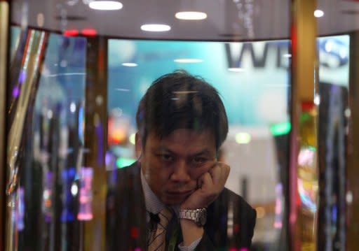 A man plays a gaming machine at the G2E Asia gaming expo in Macau on May 22. As billions of dollars pour into Asia's gleaming casinos, they are becoming the front line of a sometimes hugely lucrative battle between cheats and the house, say experts