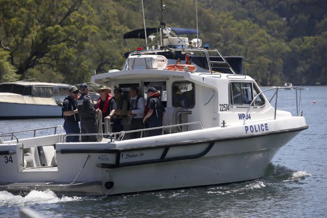 Police and and Australian Transport Safety Bureau investigators depart on a police boat to go to the scene (Rick Rycroft/AP)