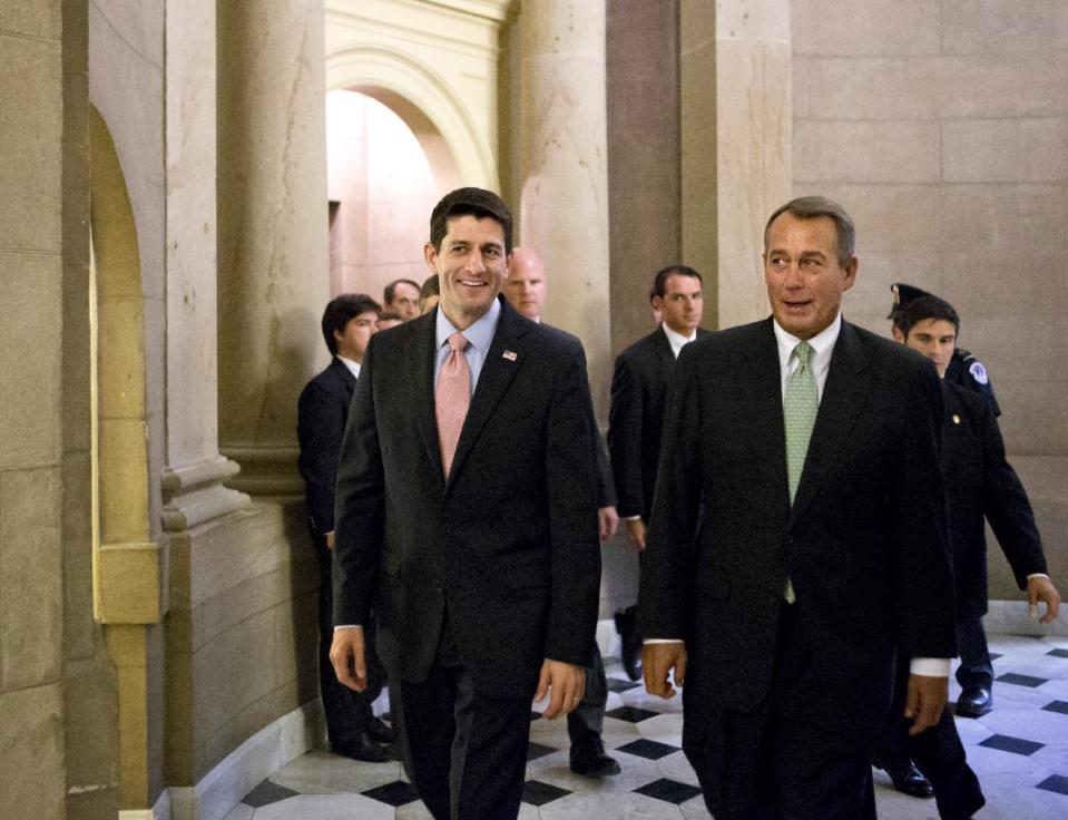 Walking with House Speaker John Boehner, R-Ohio, right, Rep. Paul Ryan, R-Wis., left, the Republican vice presidential candidate, returns to Capitol Hill to vote on a stopgap spending bill that avoids a government shutdown but carries a price tag $19 billion higher than the budget he wrote as chairman of the House Budget Committee, in Washington, Thursday, Sept. 13, 2012. (AP Photo/J. Scott Applewhite)