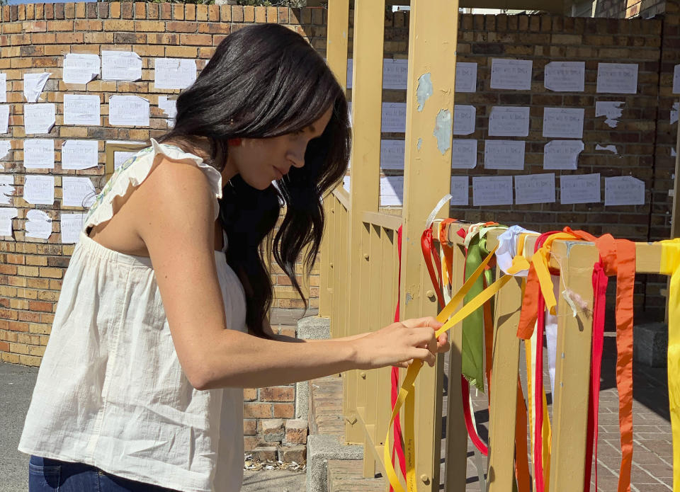 September 28, 2019: Meghan Markle ties a ribbon at the memorial to student Uyinene Mrwetyana at the post office where she was murdered last month