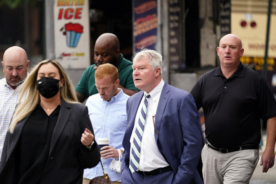 Johnny "Doc" Dougherty, cetner, walks to the federal courthouse in Philadelphia, Tuesday, Oct. 5, 2021, to face charges in his corruption trial. (AP Photo/Matt Rourke)