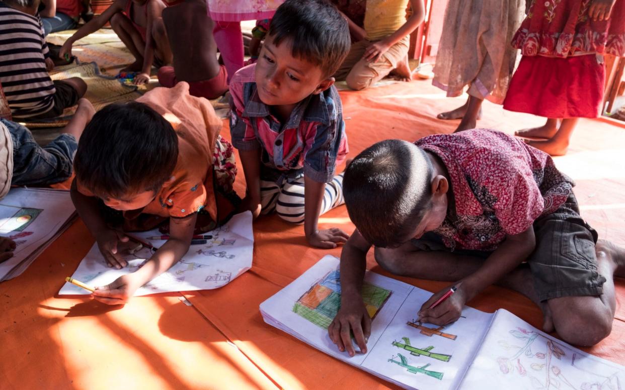 Rohingya children draw pictures to help overcome the trauma of being attacked by the military - Copyright Â©Heathcliff O'Malley