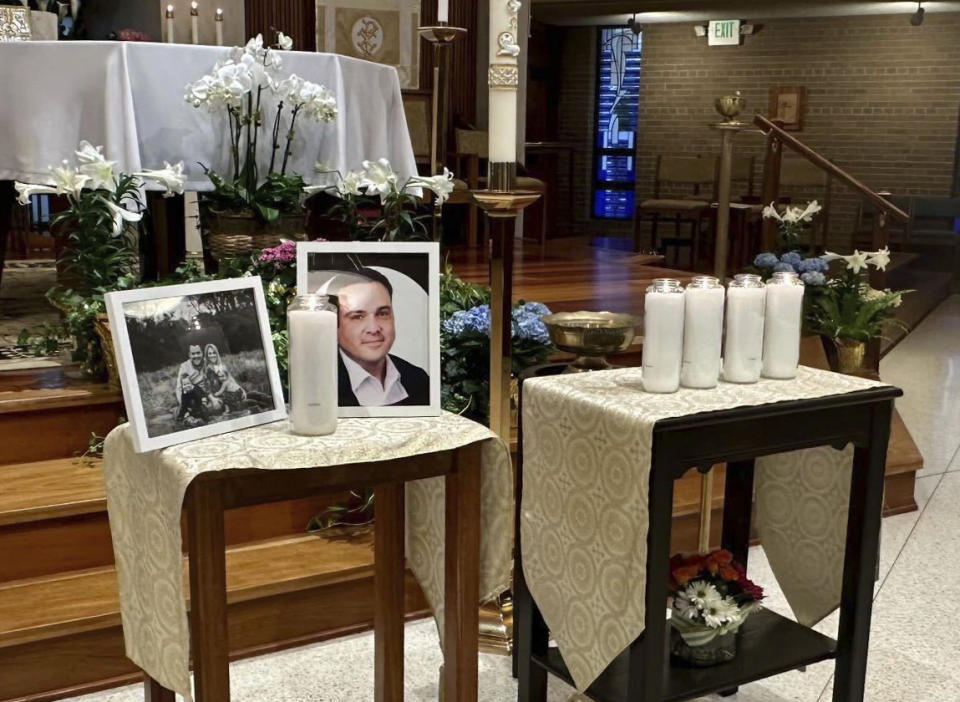 A memorial for Joshua Barrick is on display, late Monday, April 10, 2023, at Holy Trinity Catholic Church in Louisville, Ky. A Louisville bank employee armed with a rifle opened fire at the bank Monday morning, killing Barrick and multiple others, including a close friend of Kentucky's governor, while livestreaming the attack on Instagram, authorities said. (AP Photo/Claire Galofaro)