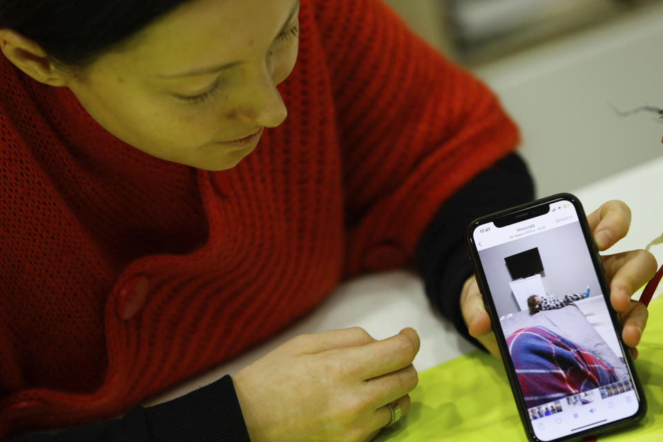 Anastasia Lasna, a Ukrainian refugee from Mykolaiv, shows a picture of her daughter during an interview with The Associated Press at the Jewish Community Center in Krakow, Poland, Saturday, Jan. 28, 2023. (AP Photo/Michal Dyjuk)