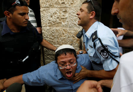 FILE PHOTO: Far-right wing activist Itamar Ben-Gvir (C) is detained by Israeli police after jeering and heckling White House Chief of Staff Rahm Emanuel (not seen) in Jerusalem's Old City May 27, 2010. REUTERS/Ronen Zvulun/File Photo