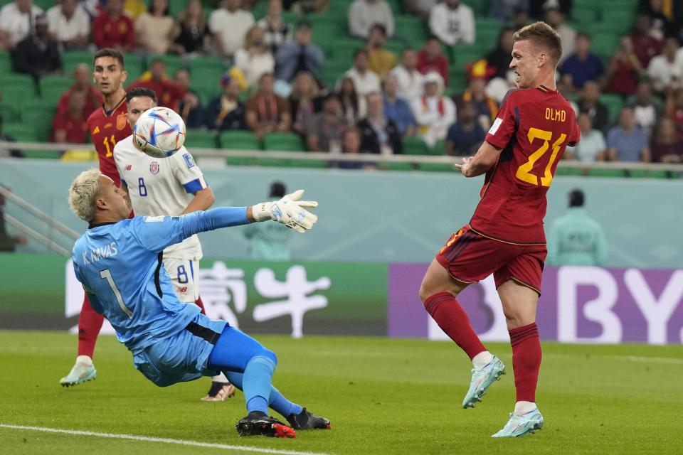 Spain's Dani Olmo, right, scores the opening goal of his team during the World Cup group E soccer match between Spain and Costa Rica, at the Al Thumama Stadium in Doha, Qatar, Wednesday, Nov. 23, 2022. (AP Photo/Alessandra Tarantino)