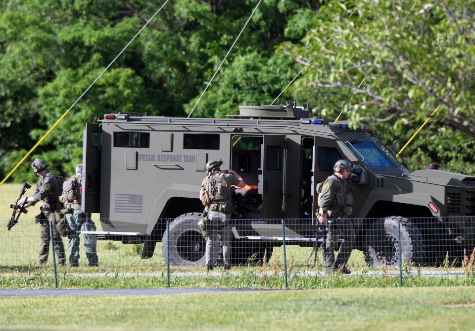 Tactical police work near where a man opened fire at a business, killing three people before the suspect and a state trooper were wounded in a shootout, according to authorities, in Smithsburg, Md., Thursday, June 9, 2022. (AP)