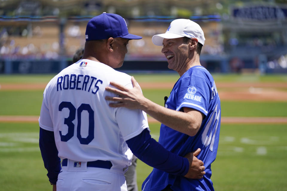 Los Angeles Dodgers manager Dave Roberts (30) greets Ryan Seacrest before a baseball game against the Minnesota Twins in Los Angeles, Wednesday, May 17, 2023. (AP Photo/Ashley Landis)