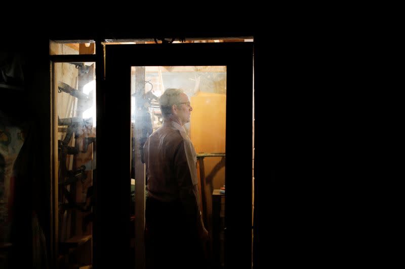 Manager and co-founder of Fortitude Ranch stands near a weapons cache at his survival camp