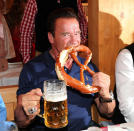 <p>Hallo, Ah-nold! Schwarzenegger got down with a <em>Brezn</em> during the Oktoberfest at Schützen-Festzelt at Theresienwiese in Munich. (Photo: Gisela Schober/Getty Images) </p>