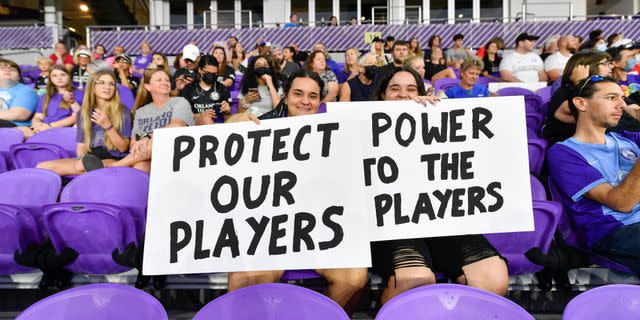Fans display their signs during a game between NJ/NY Gotham City FC and Orlando Pride following allegations of abuse