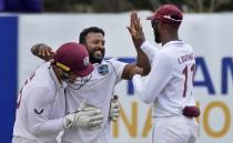 West Indies bowler Veerasammy Permaul, center, is congratulated by Joshua Da Silva and skipper Kraigg Brathwaite for taking five Sri Lankan wickets during the day two their second test cricket match in Galle, Sri Lanka, Tuesday, Nov. 30, 2021. (AP Photo/Eranga Jayawardena)