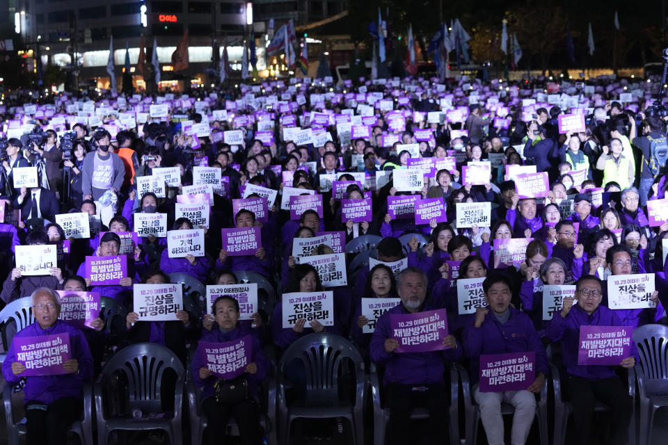 People hold the signs during a rally marking the first anniversary of the harrowing crowd surge that killed about 160 people in a Seoul alleyway, at the Seoul Plaza in Seoul, South Korea, Sunday, Oct. 29, 2023. The signs read "Find out the truth." (AP Photo/Ahn Young-joon)