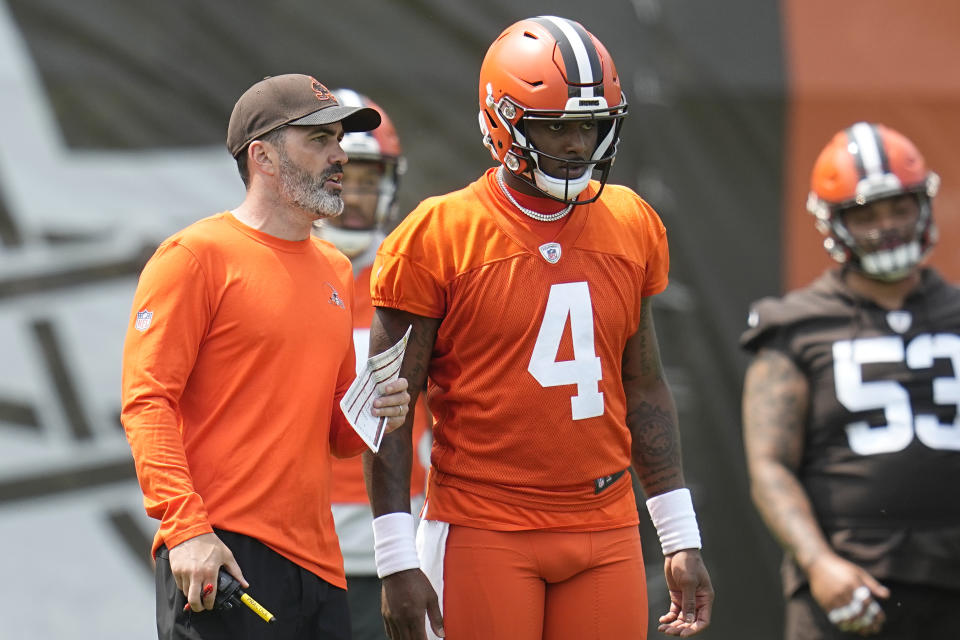 Cleveland Browns head coach Kevin Stefanski, left, talks with quarterback Deshaun Watson (4) during NFL football practice, Wednesday, May 24, 2023, in Berea, Ohio. (AP Photo/Sue Ogrocki)