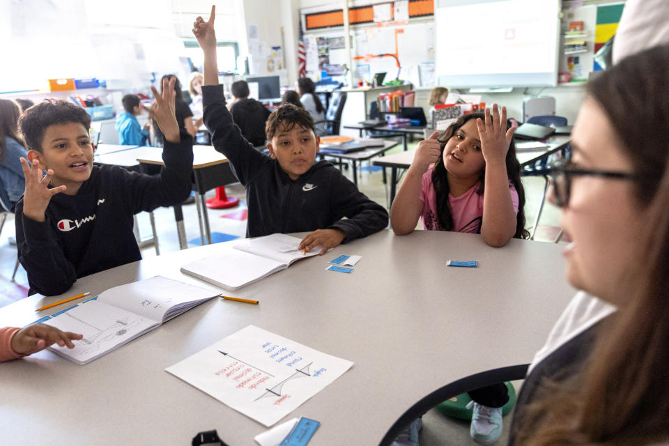 Fifth grade students attend a math lesson with teacher Alex Ventresca, right, during class at Mount Vernon Community School, in Alexandria, Va., Wednesday, May 1, 2024. (AP Photo/Jacquelyn Martin)