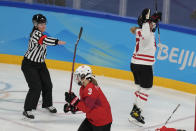 Canada's Emma Maltais, right, celebrates after scoring a goal against Switzerland during a women's semifinal hockey game at the 2022 Winter Olympics, Monday, Feb. 14, 2022, in Beijing. Skating away s Switzerland's Sarah Forster (3). (AP Photo/Petr David Josek)