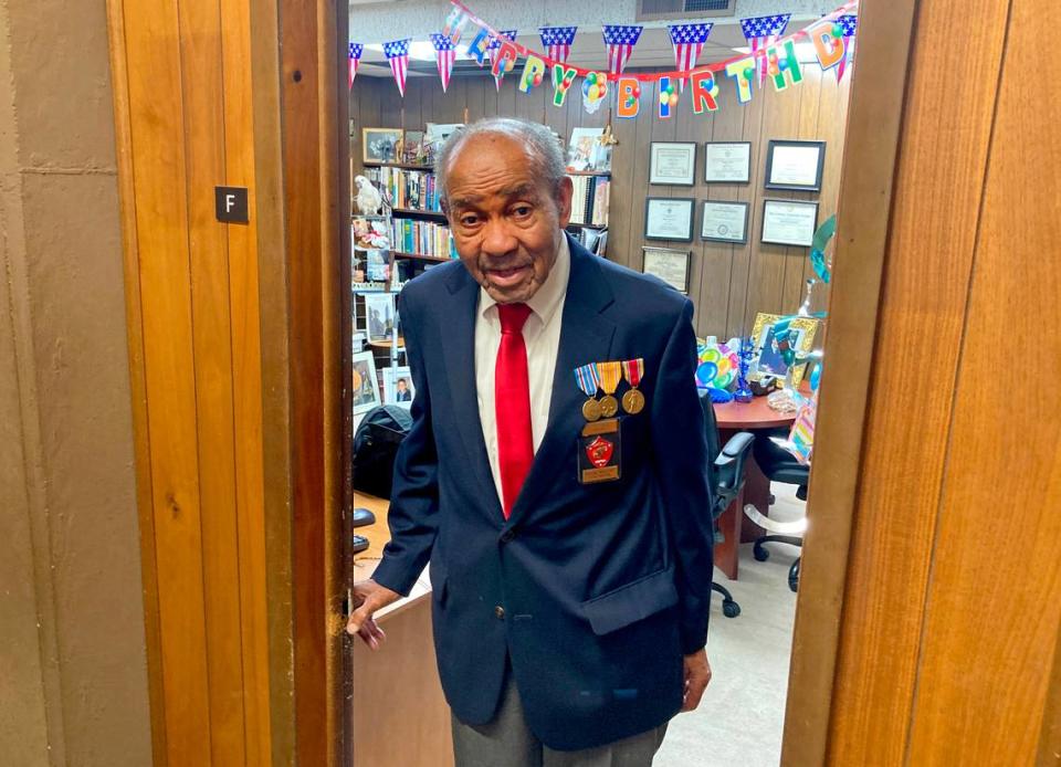 Rev. Wortham Fears stands in the doorway to his office at the Christian Cathedral in Oakland earlier this month, wearing his medals and the Navy blue blazer, white shirt and red tie that Montford Point Marines wear as part of their uniform. Graham Womack/Special to The Bee