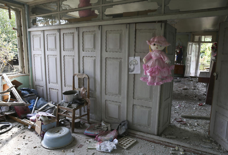 Damage is seen inside an apartment building that was allegedly damaged by recent shelling during fighting over the breakaway region of Nagorno-Karabakh in Tartar region, Azerbaijan, Wednesday, Sept. 30, 2020. Leaders of Azerbaijan and Armenia brushed off the suggestion of peace talks Tuesday, accusing each other of obstructing negotiations over the separatist territory of Nagorno-Karabakh, with dozens killed and injured in three days of heavy fighting. (AP Photo/Aziz Karimov)