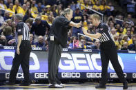 West Virginia coach Bob Huggins speaks with an official during the first half of an NCAA college basketball game against Missouri Saturday, Jan. 25, 2020, in Morgantown, W.Va. (AP Photo/Kathleen Batten)