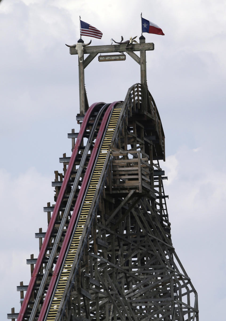 The Texas Giant roller coaster ride sits idle at the Six Flags Over Texas park Saturday, July 20, 2013, in Arlington, Texas. Investigators will try to determine if a woman who died while riding the roller coaster at the amusement park Friday night fell from the ride after some witnesses said she wasn't properly secured.(AP Photo/LM Otero )