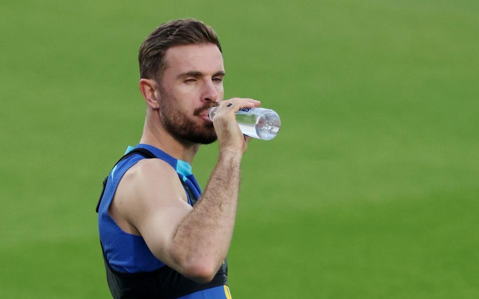 England's Jordan Henderson hydrates in the heat - Carl Recine/Reuters