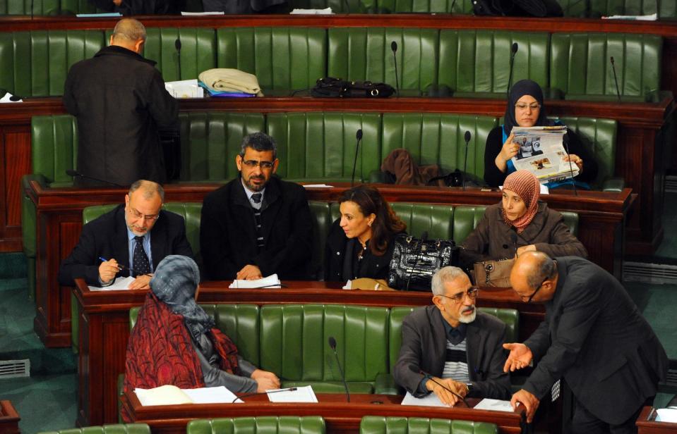 In this photo dated Thursday, Jan. 23, 2014, members of the Constitutional Assembly attend a session as part of the debates on the new constitution in Tunis, Tunisia. The spokesman for Tunisia's Constitutional Assembly says a final vote on a new constitution will take place Saturday, now that members have approved each of the new articles in the historic document. (AP Photo/Hassene Dridi)