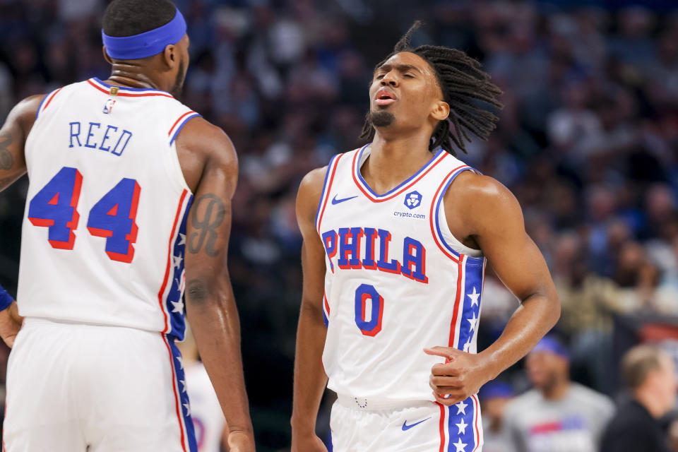Philadelphia 76ers guard Tyrese Maxey (0) celebrates with forward Paul Reed (44) during the first half of an NBA basketball game against the Dallas Mavericks, Sunday, March 3, 2024, in Dallas. (AP Photo/Gareth Patterson)