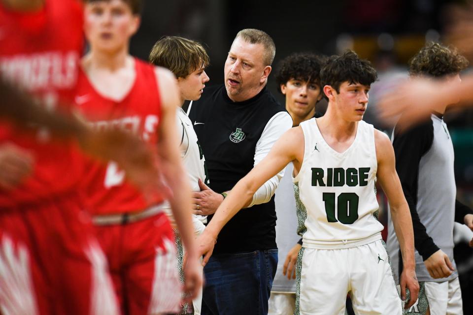 Fossil Ridge coach Matt Johannsen talks to SaberCats player Domenic Leone coming out of a timeout during the 6A state championship against Denver East at the Denver Coliseum on Saturday, March 11, 2023, in Denver, Colo. The SaberCats lost 82-61.