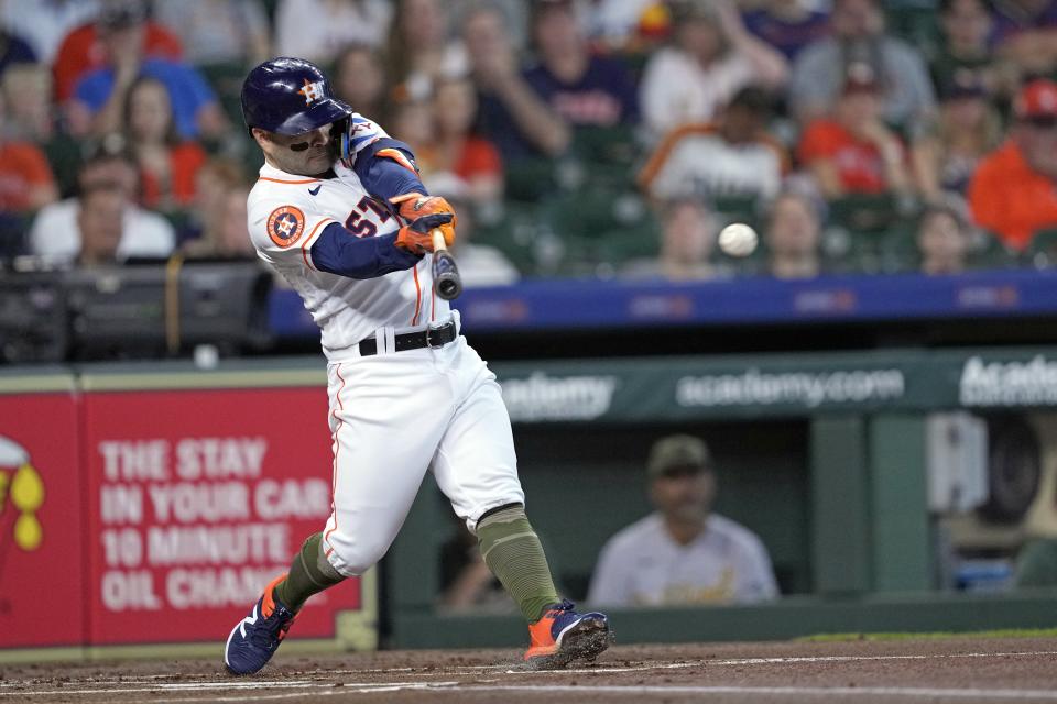 Houston Astros' Jose Altuve hits a double during the first inning of a baseball game against the Oakland Athletics Saturday, May 20, 2023, in Houston. (AP Photo/David J. Phillip)