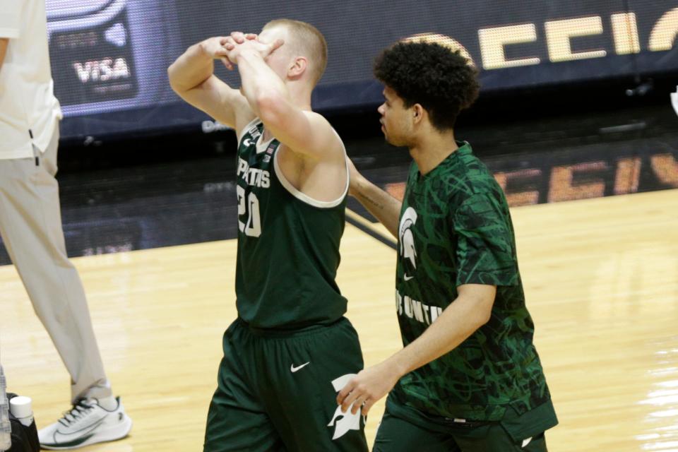 Michigan State forward Joey Hauser (20) reacts as he walks off the court with a teammate after Michigan State was defeated by Purdue, 75-65, Tuesday, Feb. 16, 2021 at Mackey Arena in West Lafayette.