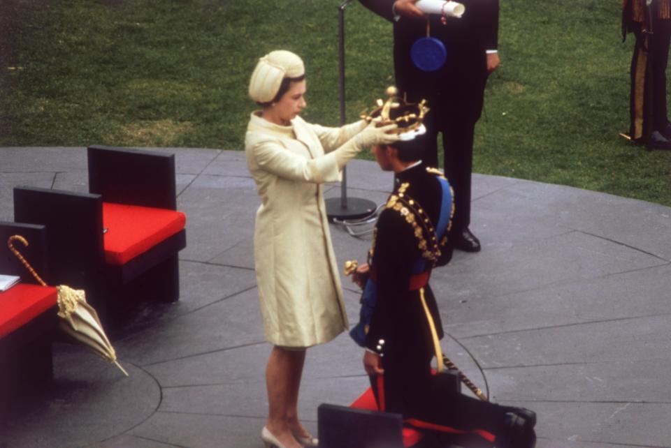 1st July 1969:  Queen Elizabeth II crowns her son Charles, Prince of Wales, during an investiture ceremony at Caernarvon Castle.  (Photo by Hulton Archive/Getty Images)