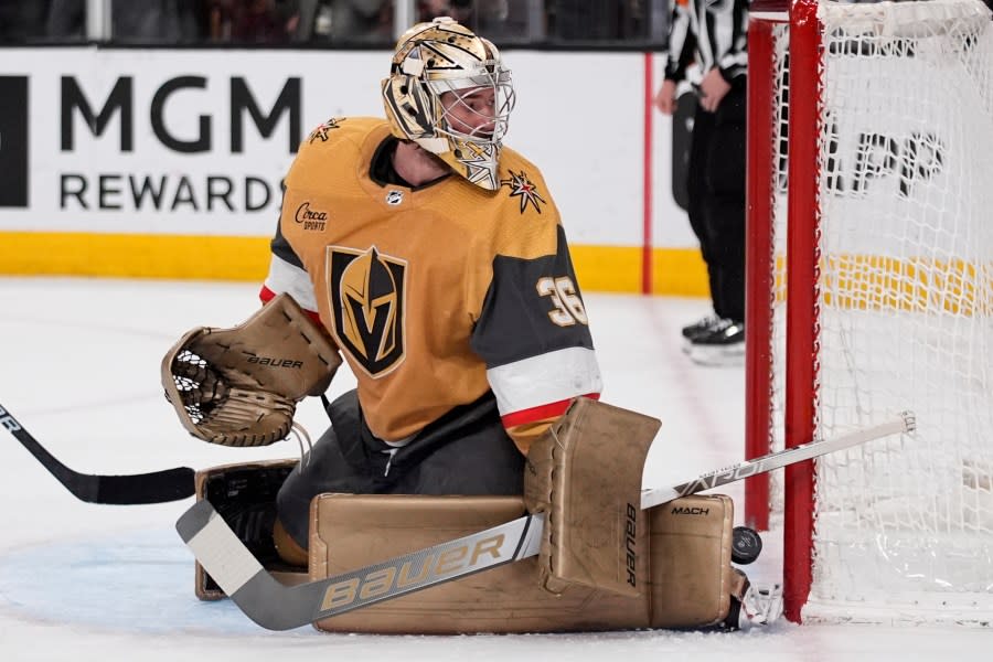 Vegas Golden Knights goaltender Logan Thompson (36) blocks a shot by the Vancouver Canucks during the first period of an NHL hockey game Tuesday, April 2, 2024, in Las Vegas. (AP Photo/John Locher)