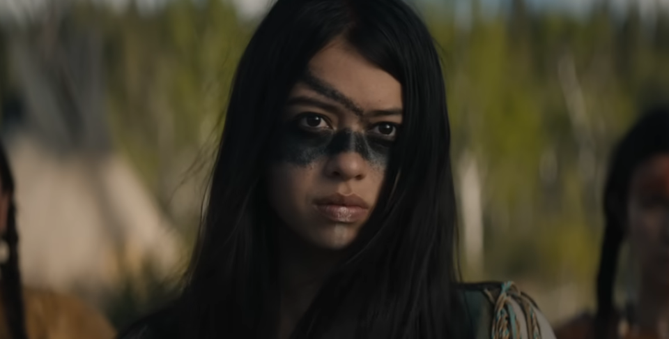 closeup of a woman with war paint on her face