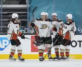 Anaheim Ducks right wing Alexander Volkov (92) celebrates with teammates Cam Fowler (4), Sam Carrick (39), and Andy Welinski (45) after scoring a goal against the San Jose Sharks during the first period of an NHL hockey game Monday, April 12, 2021, in San Jose, Calif. (AP Photo/Tony Avelar)