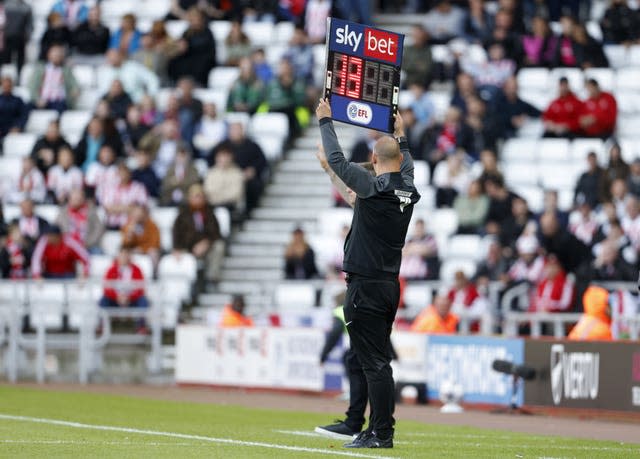 The fourth official holds up a board displaying 13 minutes of added time in the second half of Sunderland's game against Ipswich