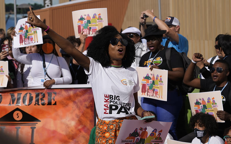 Demonstrators participate in a Kick Big Polluters Out protest