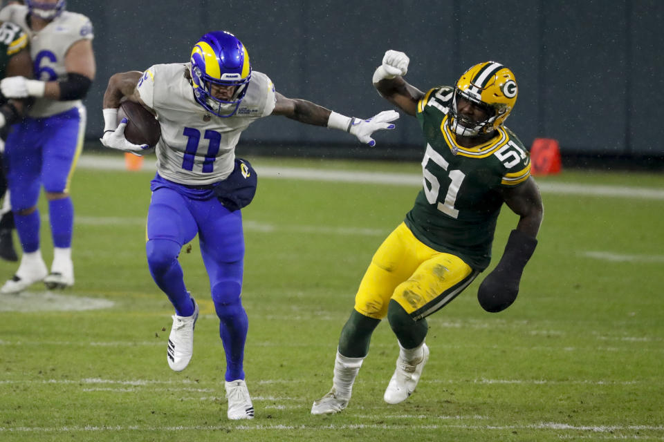 Los Angeles Rams' Josh Reynolds breaks away from Green Bay Packers' Krys Barnes during the first half of an NFL divisional playoff football game, Saturday, Jan. 16, 2021, in Green Bay, Wis. (AP Photo/Mike Roemer)