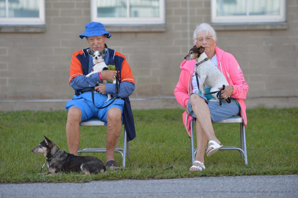 Ken Rickard and Mary Horner, residents of Rambler's Rest RV Restort in Venice, Florida, sit with their dogs, from left, Joey, Munchkin and Wishbone, at the Venice High School hurricane shelter following Hurricane Ian on Monday, Oct. 3, 2022. Rickard and Horner had to be evacuated by deputies from the Sarasota County Sheriff's Office in a boat. They had stayed in their house during the storm. "We didn't know which way to go. We didn't know which was the storm was going to go," Rickard said about evacuating. "All the hotels were booked." They had to leave when water from the Myakka River began to rise and was shin-deep in their lanai.