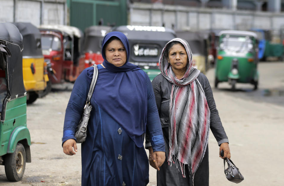 Sri Lankan Muslim women walk in a street in Colombo, Sri Lanka, Tuesday, Aug. 27, 2019. Islamic clerics in Sri Lanka asked Muslim women on Tuesday to continue to avoid wearing face veils until the government clarifies whether they are once again allowed now that emergency rule has ended four months after a string of suicide bomb attacks. (AP Photo/Eranga Jayawardena)