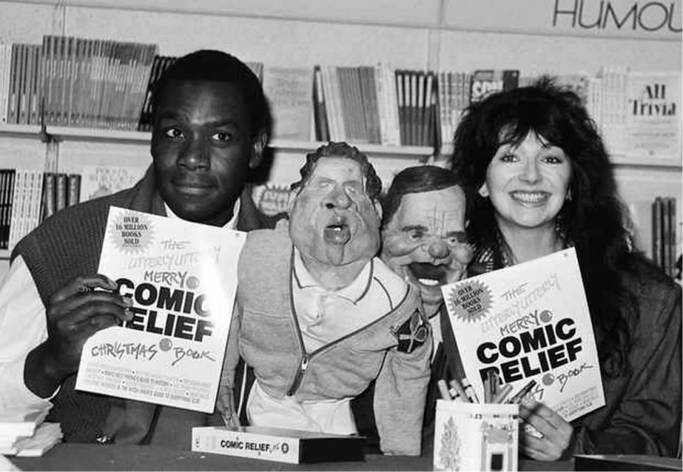 1986: Spitting Image puppets of John McEnroe and Jefferey Archer flanked by Lenny Henry and Kate Bush at the launch of the comic relief book. (PA)