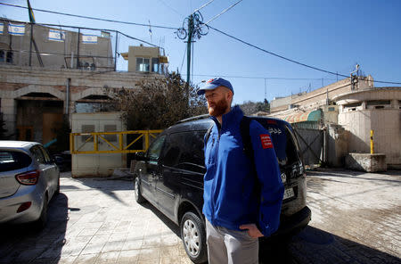 A member of the Temporary International Presence in Hebron (TIPH) stands near the Beit Romano settlement in Hebron, in the Israeli-occupied West Bank January 29, 2019. REUTERS/Mussa Qawasma