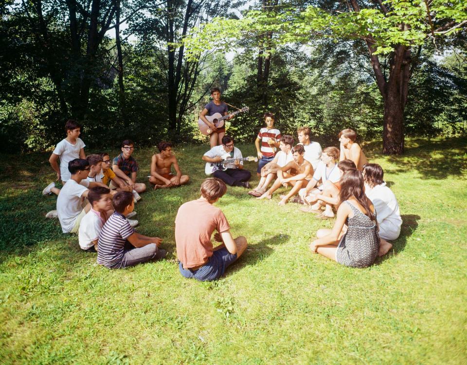 vacationers at the pine grove motel seated in a circle, having a sing along photo by eric bardcorbis via getty images