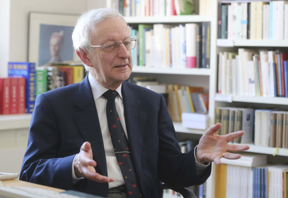 In this photo taken Tuesday, April 2, 2013, Michael Edwards speaks during an interview with The Associated-Press at his office at the College de France in Paris. The man who will soon become the newest official guardian of the French language has spoken: English, he says, is jumping the barricades and threatening the language of Moliere. Edwards should know. He's British - the first to become one of the 40 esteemed “immortals” of the Academie Francaise, the institution that has watched over the French language since 1635. (AP Photo/Michel Euler)