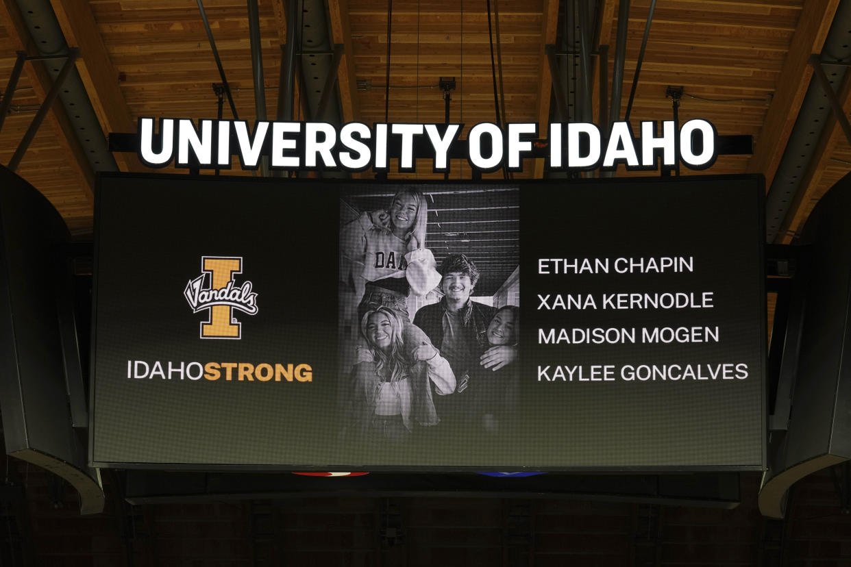 A photo and the names of four University of Idaho students who were killed over the weekend at a residence near campus are displayed during a moment of silence, Wednesday, Nov. 16, 2022, before an NCAA college basketball game between Idaho and Cal-State Bakersfield in Moscow, Idaho. (AP Photo/Ted S. Warren)
