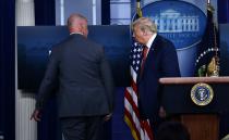 US President Donald Trump is being removed by a member of the secret service from the Brady Briefing Room of the White House in Washington, DC, on August 10, 2020. - Secret Service guards shot a person, who was apparently armed, outside the White House on August 10, 2020. President Donald Trump said just after being briefly evacuated in the middle of a press conference. (Photo by Brendan Smialowski / AFP) (Photo by BRENDAN SMIALOWSKI/AFP via Getty Images)