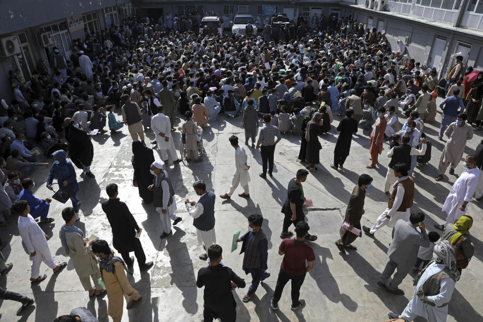 FILE - Afghans wait inside the passport office in Kabul, Afghanistan, Wednesday, June 30, 2021. Afghans are lining up by the thousands at the Afghan Passport office to get new passports, possibly to leave, as they witness the final withdrawal of the U.S. military and its NATO allies. The Afghan man who speaks only Farsi represented himself in U.S. immigration court, and the judge denied him asylum. The Associated Press obtained a transcript of the hearing that offers a rare look inside an opaque and overwhelmed immigration court system where hearings are closed and judges are under pressure to move quickly given the backlog of 2 million cases. (AP Photo/Rahmat Gul, File)