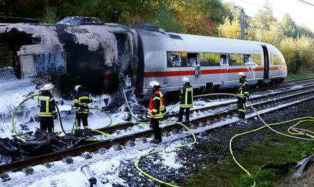 Firefighters work at a destroyed German high speed ICE train after it caught fire on the way from Cologne to Frankfurt in Dierdorf, Germany, October 12, 2018. REUTERS/Wolfgang Rattay