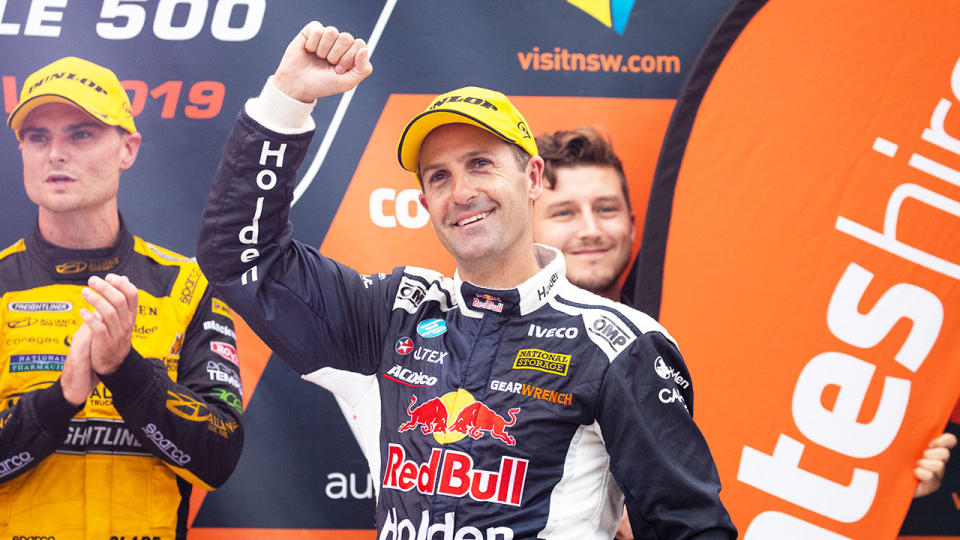 Pictured here, Holden driver Jamie Whincup salutes Supercars fans.