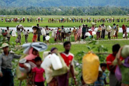 Rohingya refugees, who crossed the border from Myanmar two days before, walk after they received permission from the Bangladeshi army to continue on to the refugee camps, in Palang Khali, near Cox's Bazar, Bangladesh October 19, 2017. REUTERS/Jorge Silva/File Photo